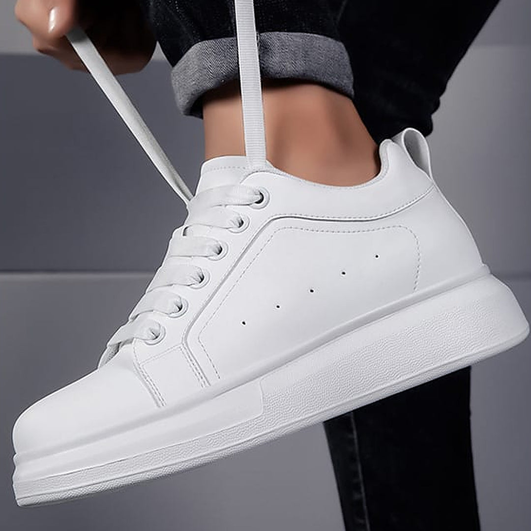 Tying the wide white laces of the Ratio Lumen sneaker